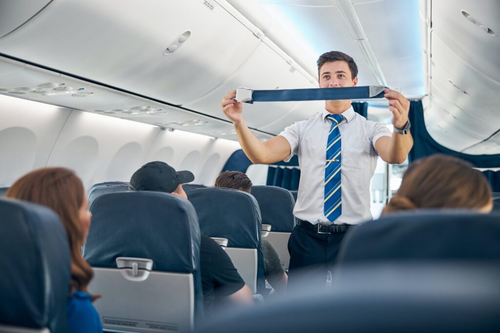 handsome-steward-training-safety-prior-procedures-to-flight-take-off.jpg